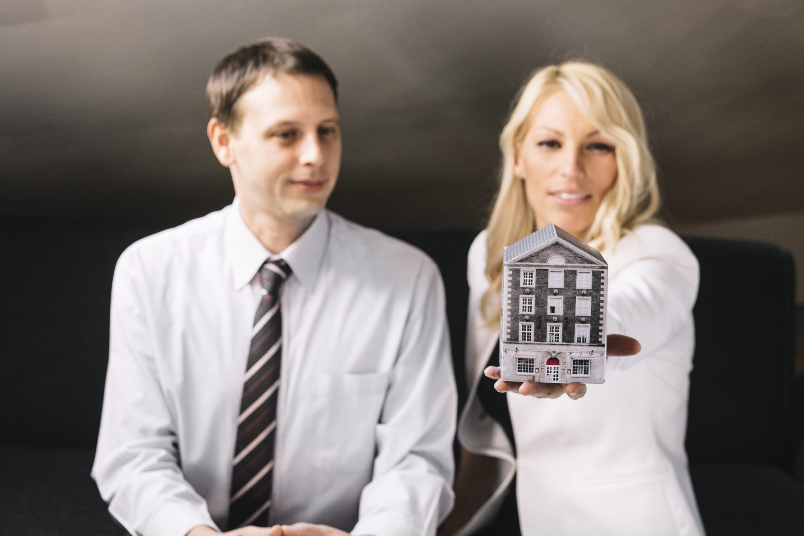 real-estate-agent-holding-toy-house